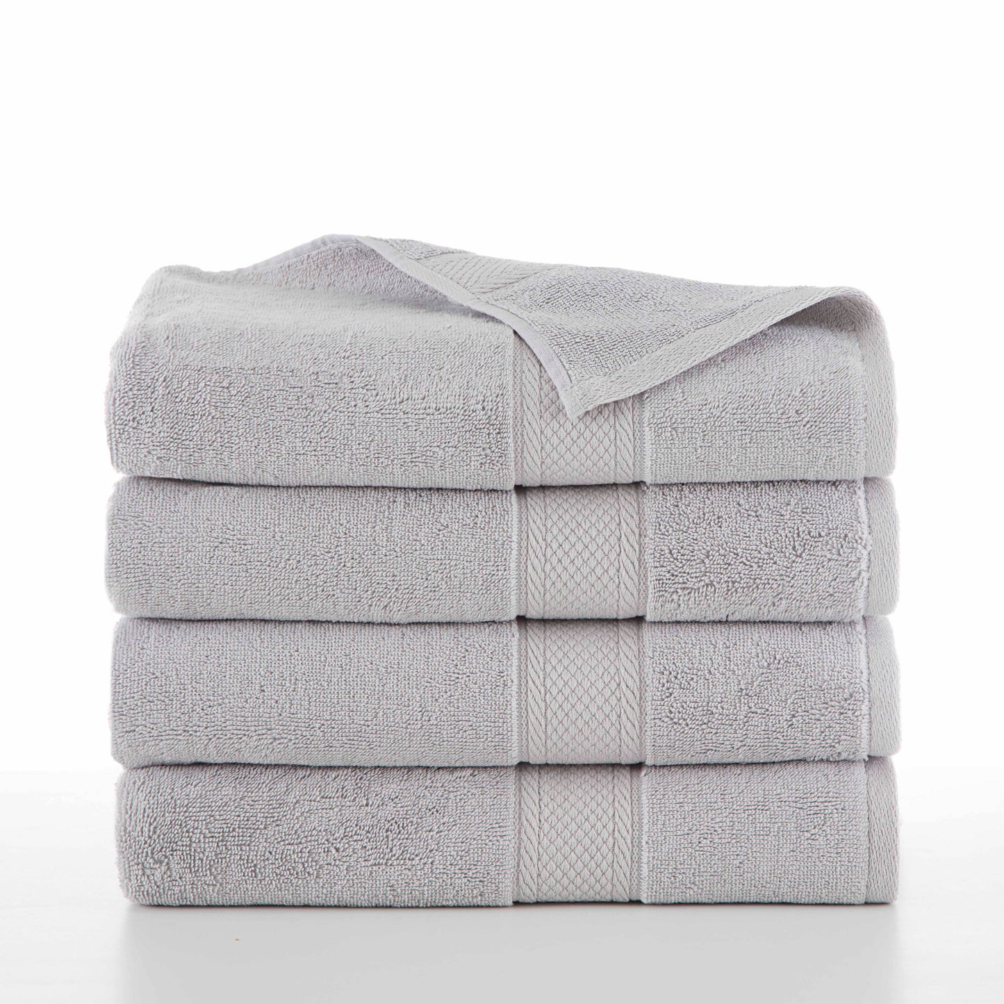 four grey towels folded in a stack