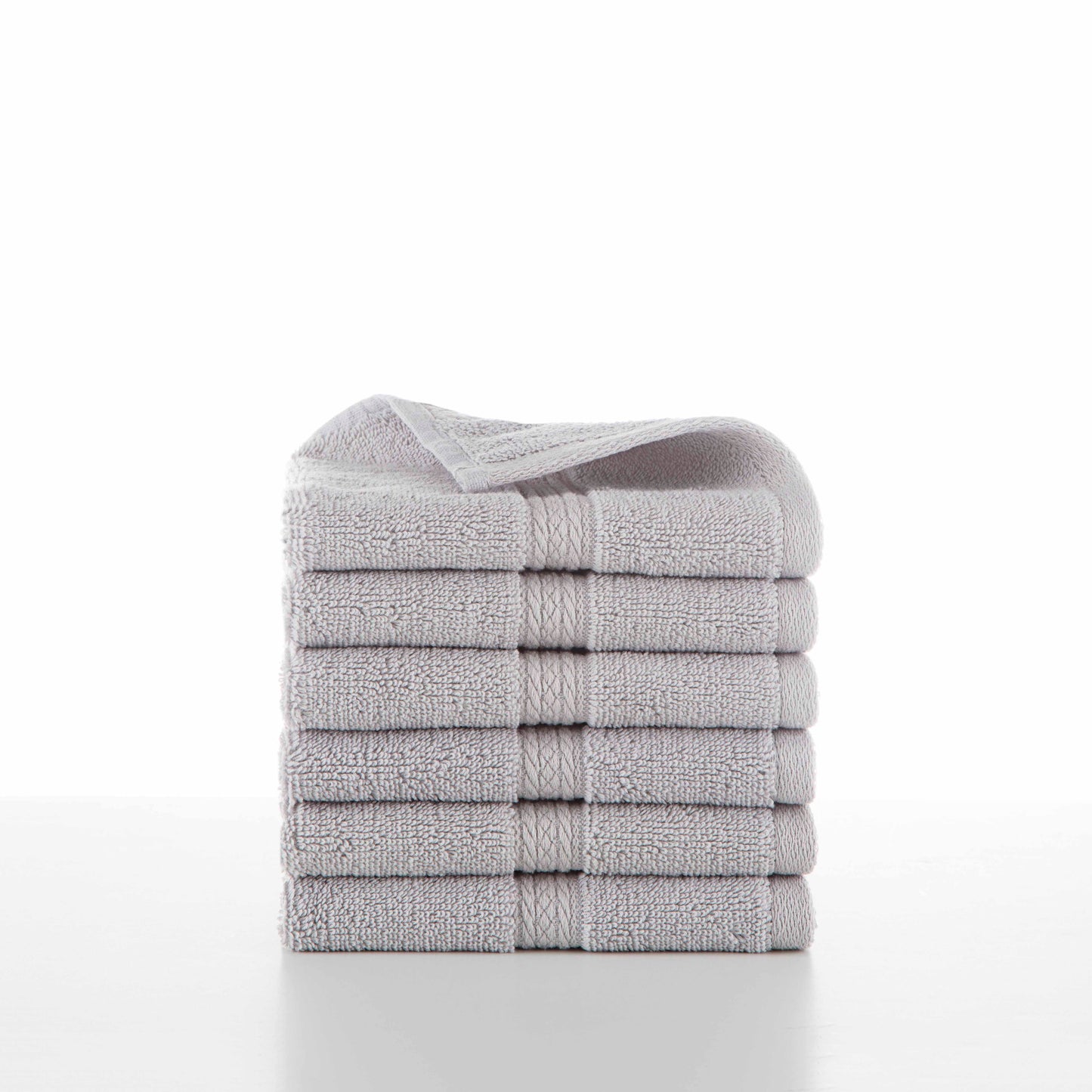 six grey towels in a stack