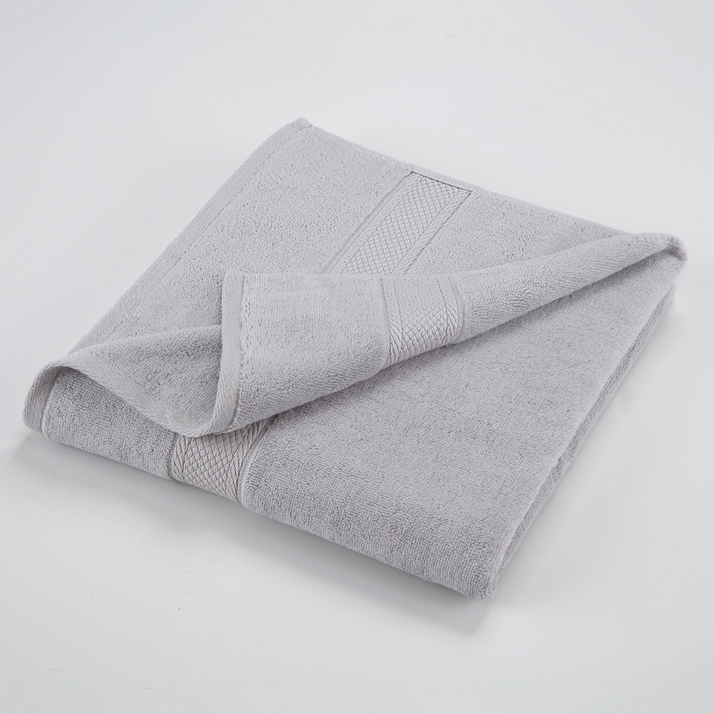 one grey towel folded with one edge highlighted