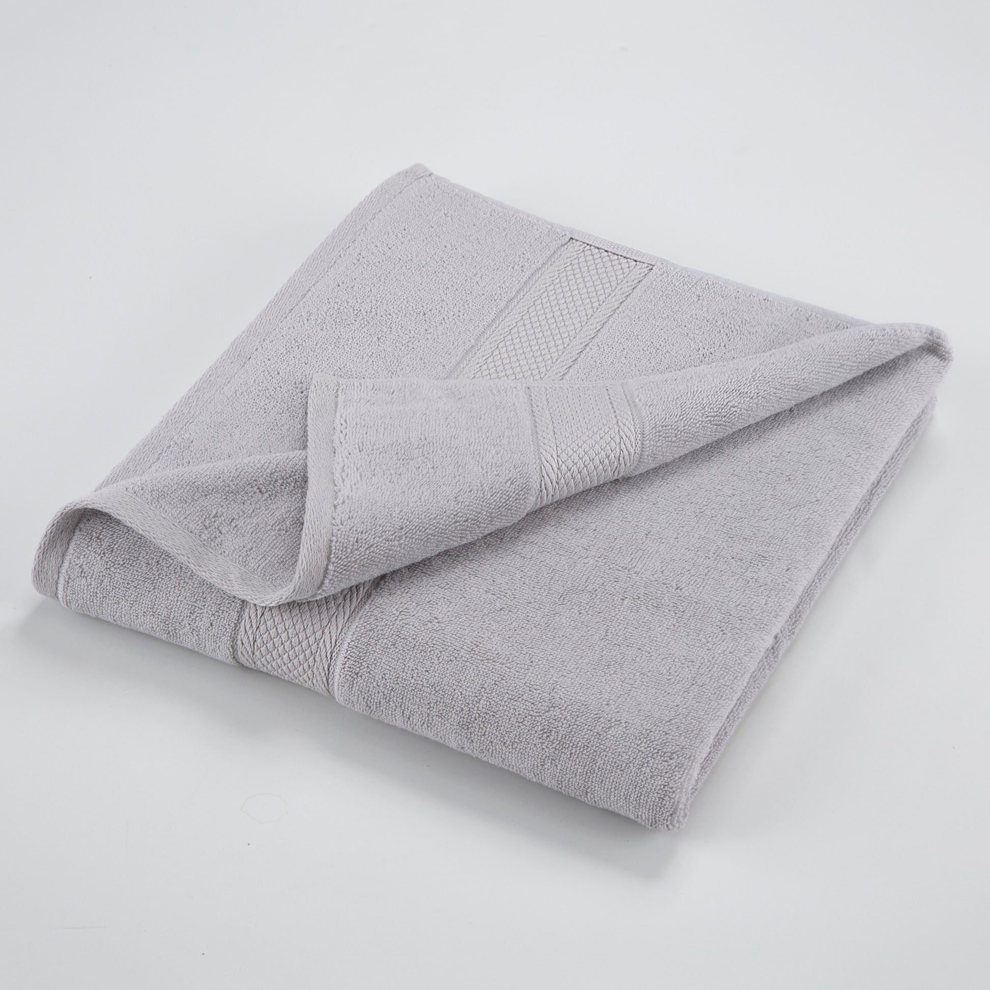 one grey towel folded with one edge highlighted
