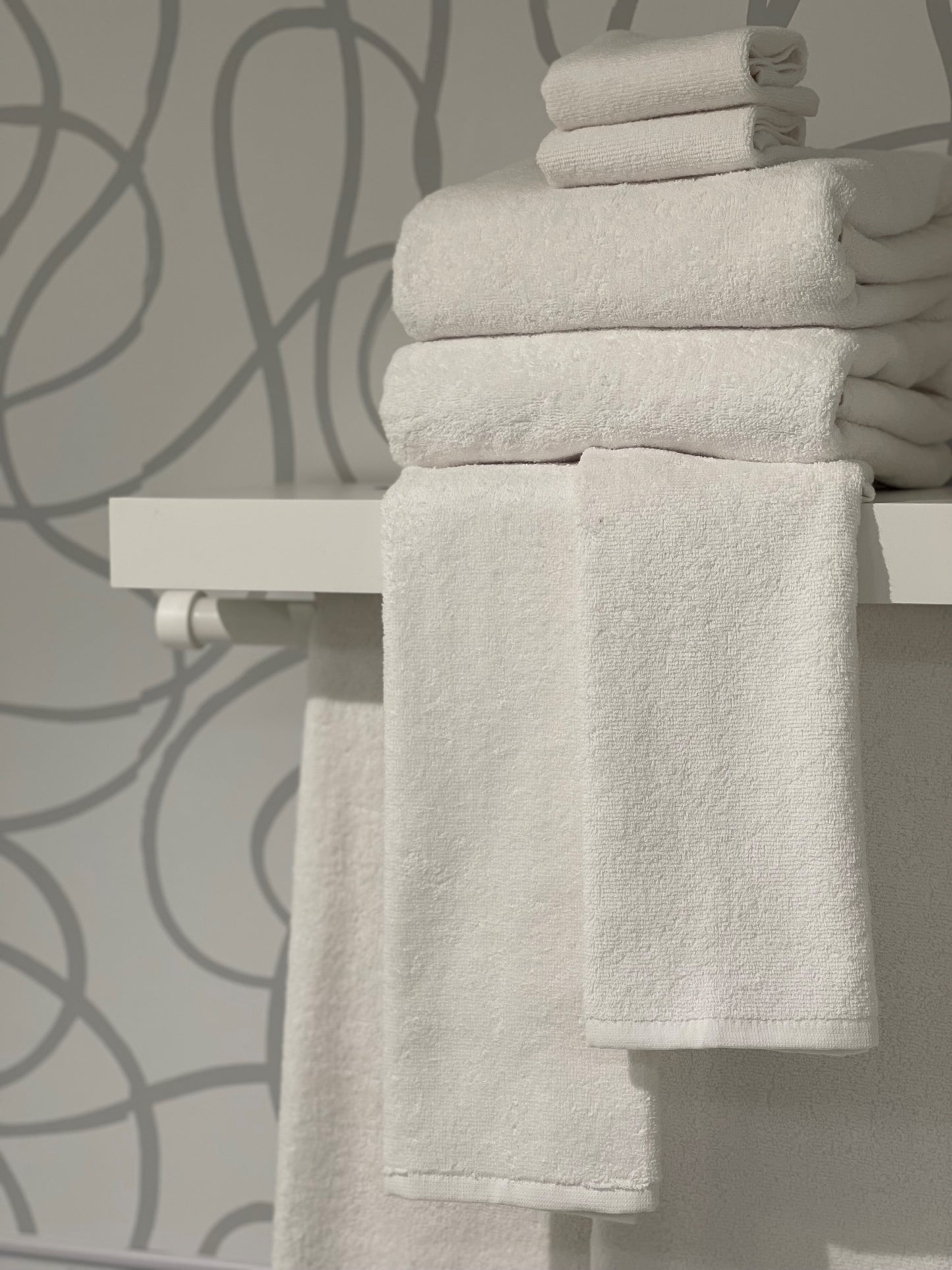 white towels on rack and ledge