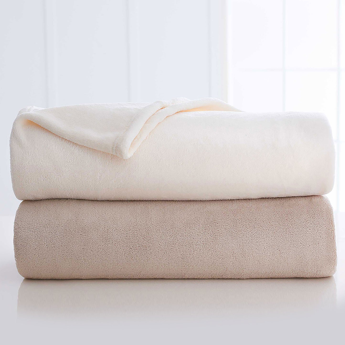 stack of two ivory blankets