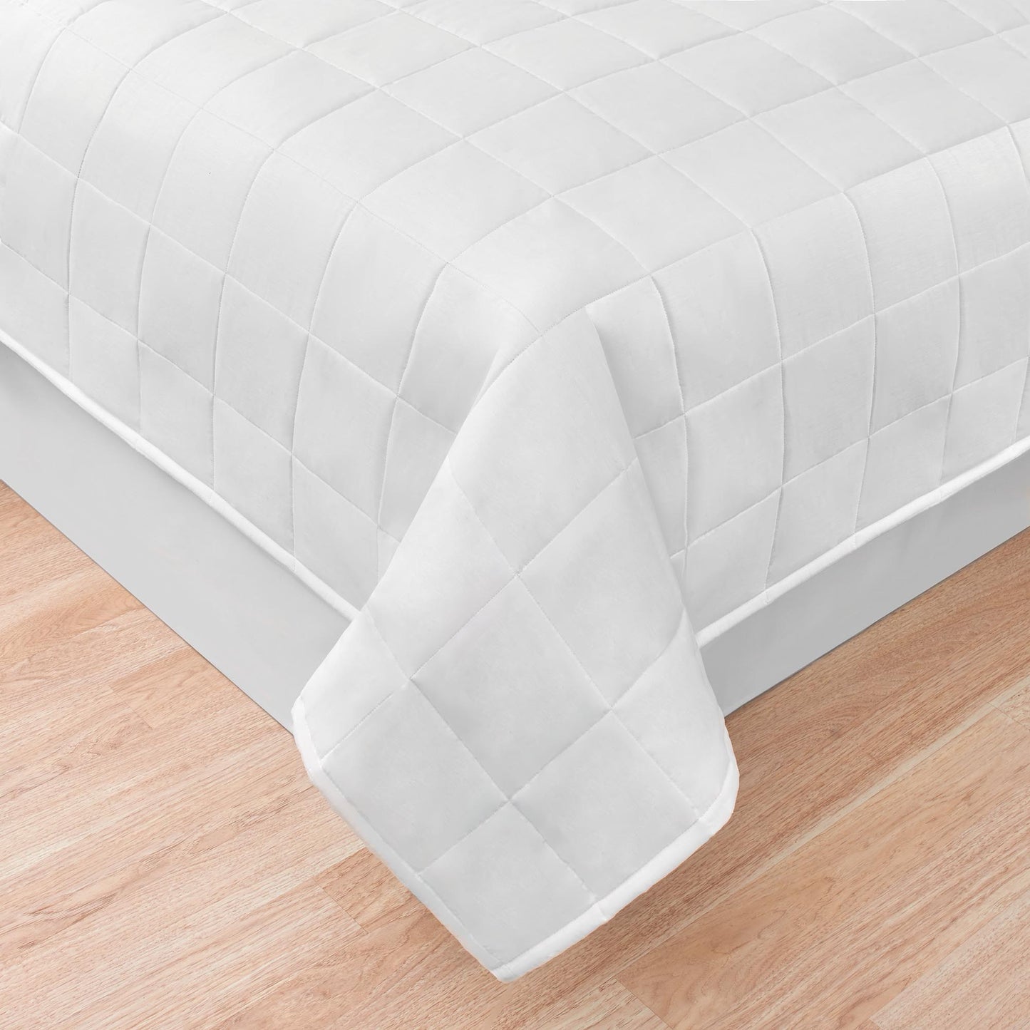 one corner of white quilted comforter