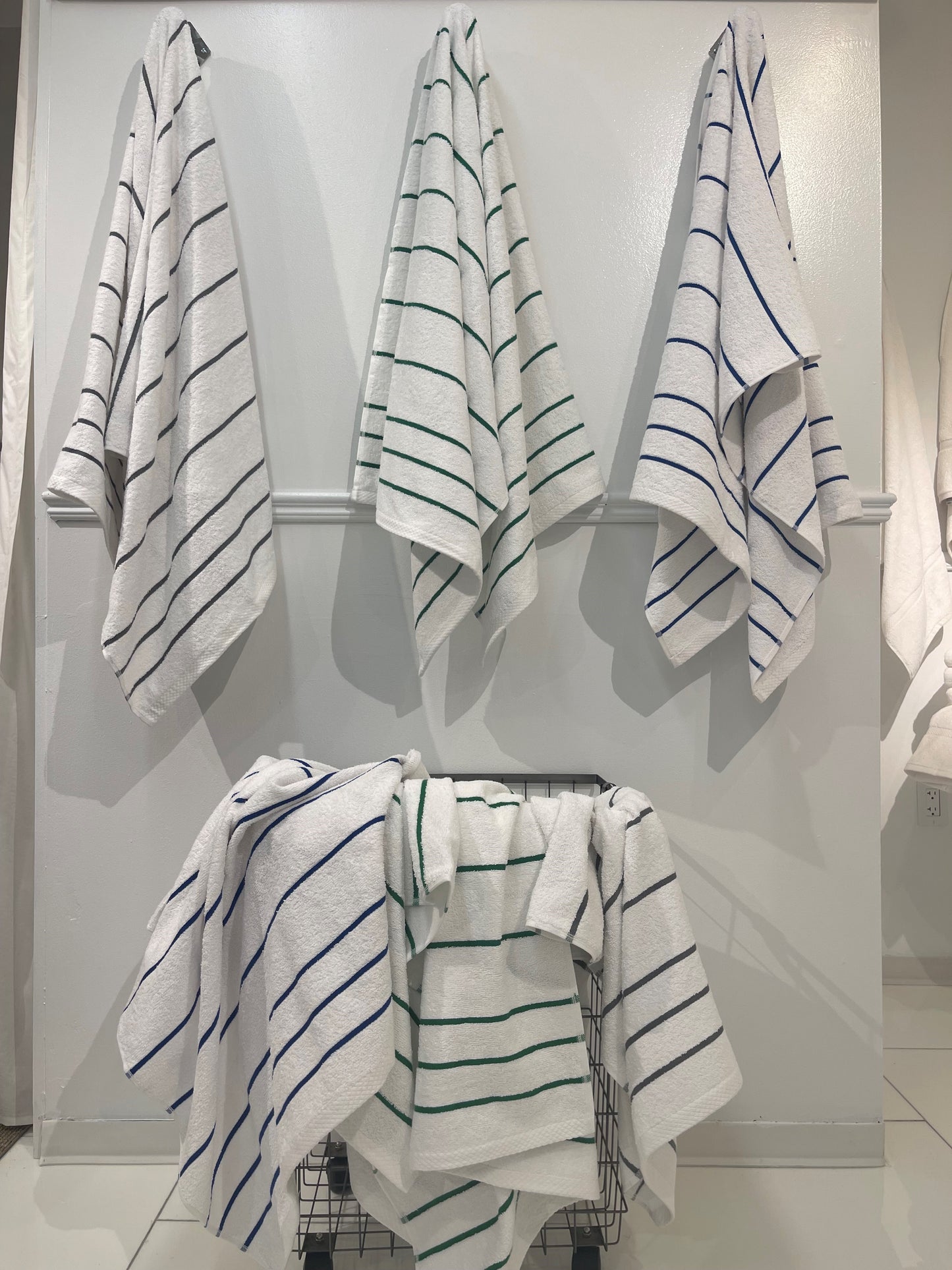 three pool towels hung and many in basket