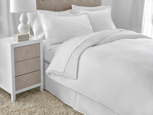 White solid duvet cover shown on bed