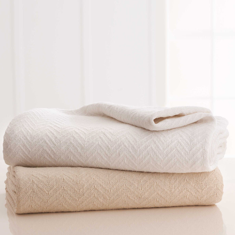 stack of two blankets, one white and one natural