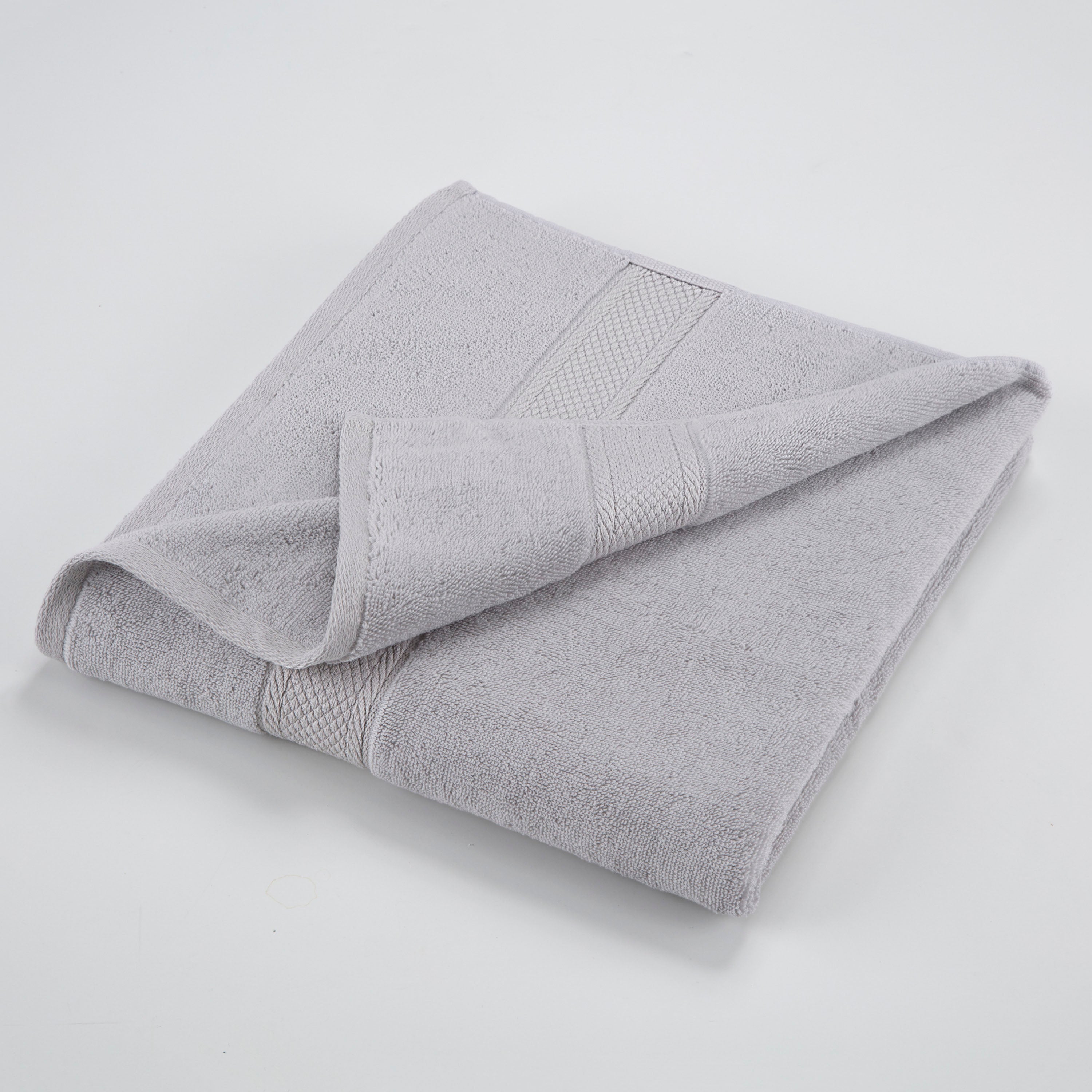 one grey towel folded with one edge highlighted