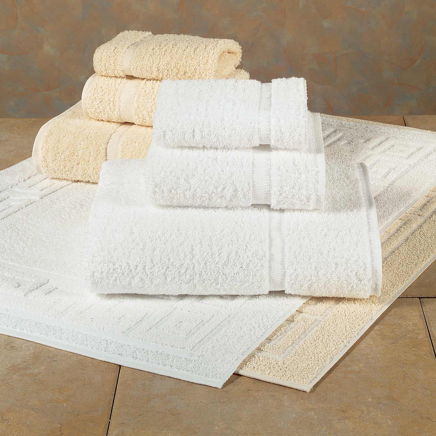 two stacks of towels, one white one ecru