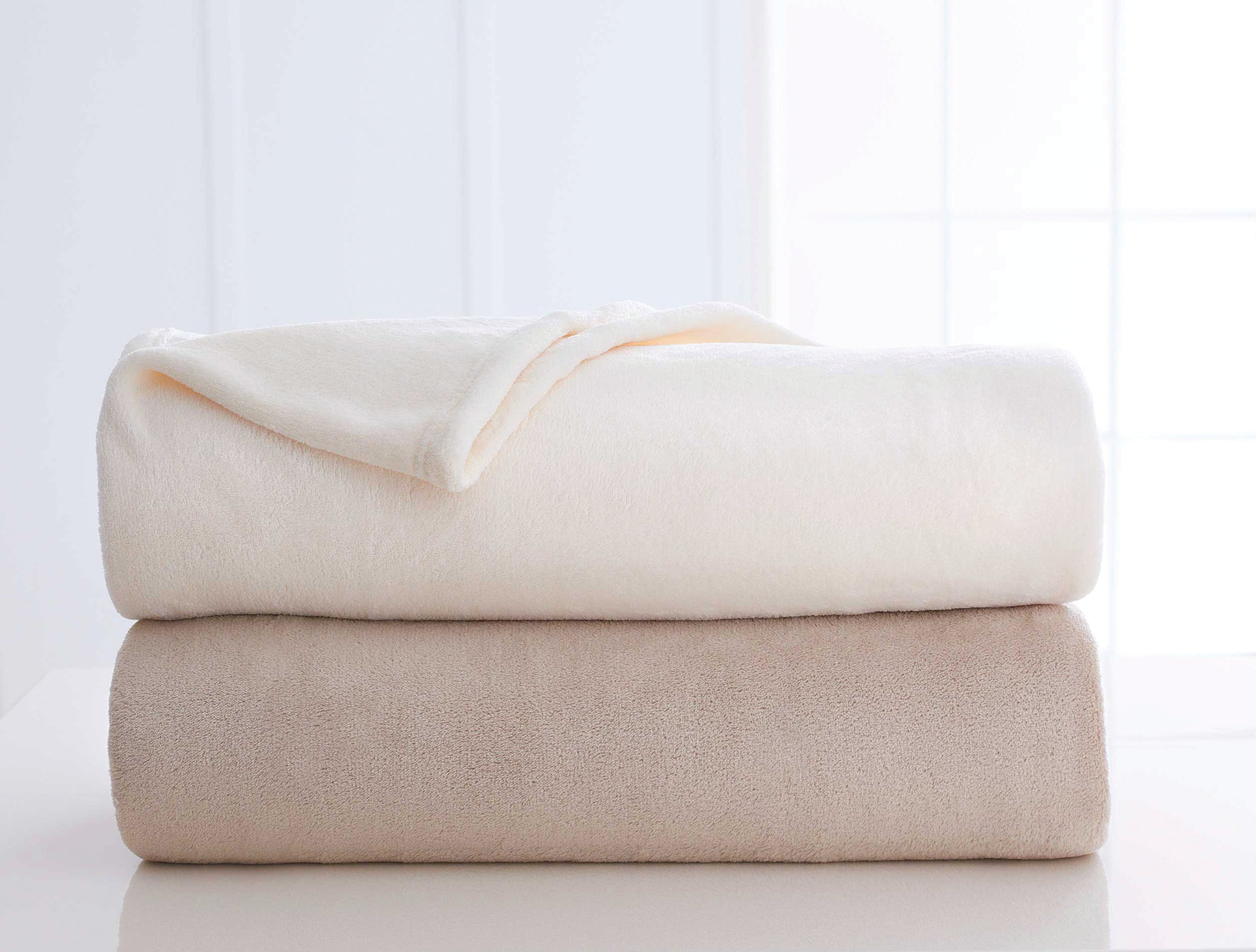 stack of tan and ivory blankets